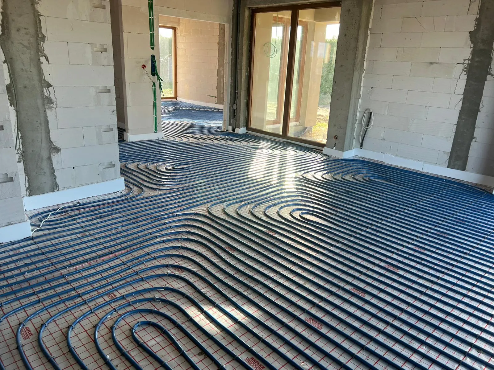Underfloor heating pipe loops installed in a residential building under construction